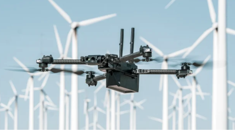 drone flying in front of windmills