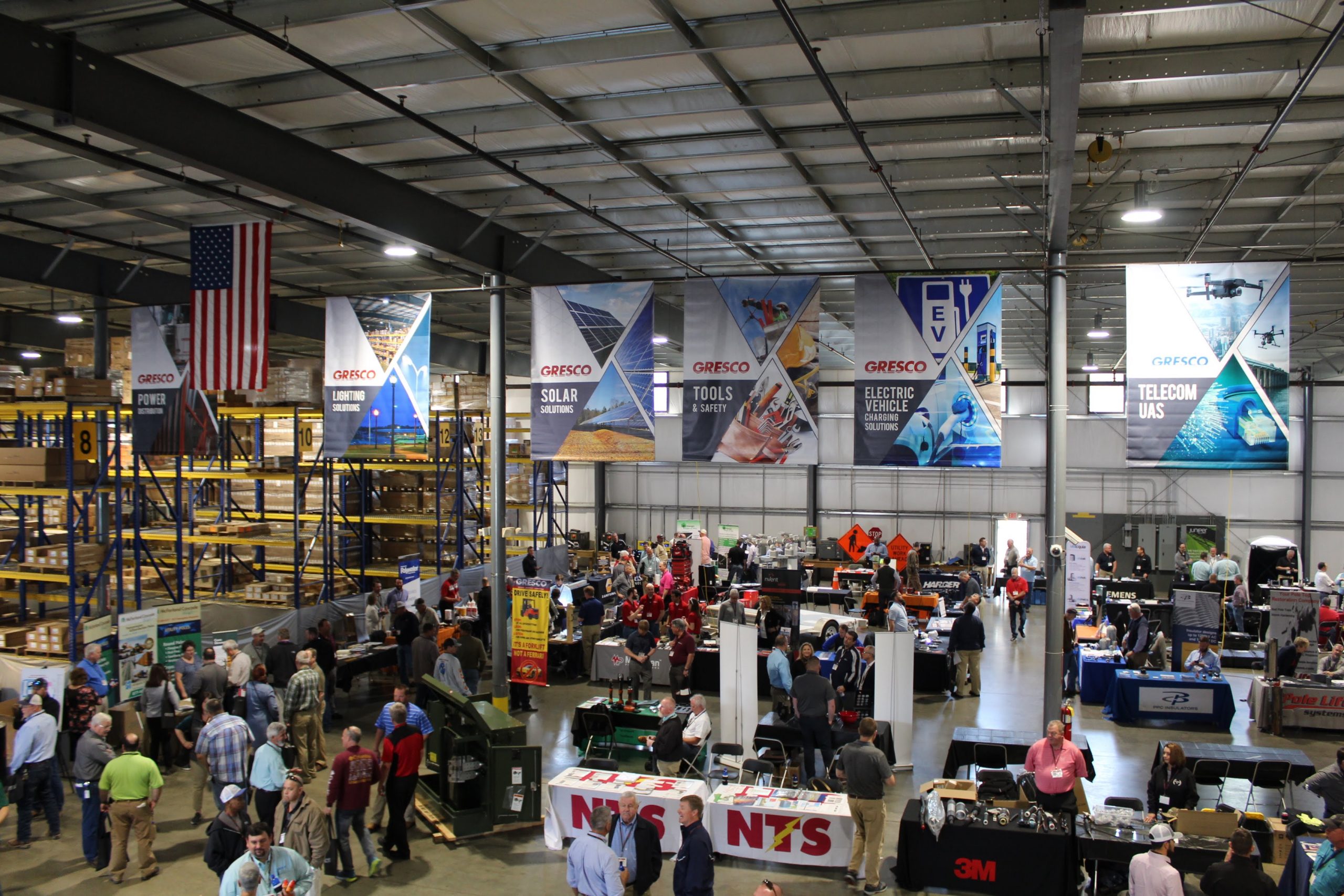 Gresco 19th Annual Expo - vendors, clients, and employees mingle in the Gresco warehouse under Gresco banners.